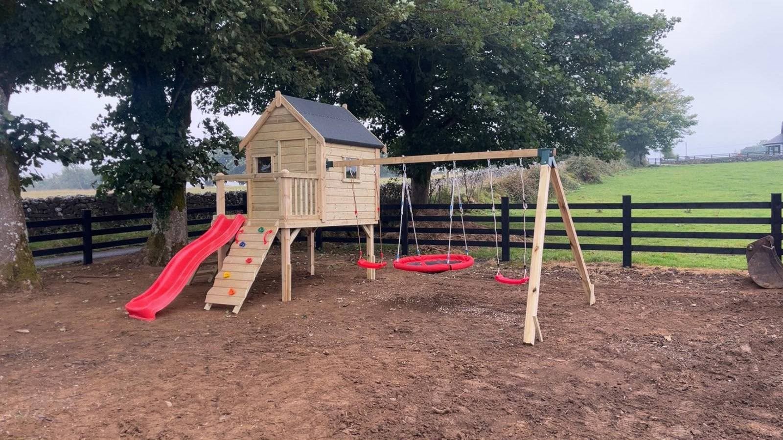 Otters Cottage playhouse with slide and swing set